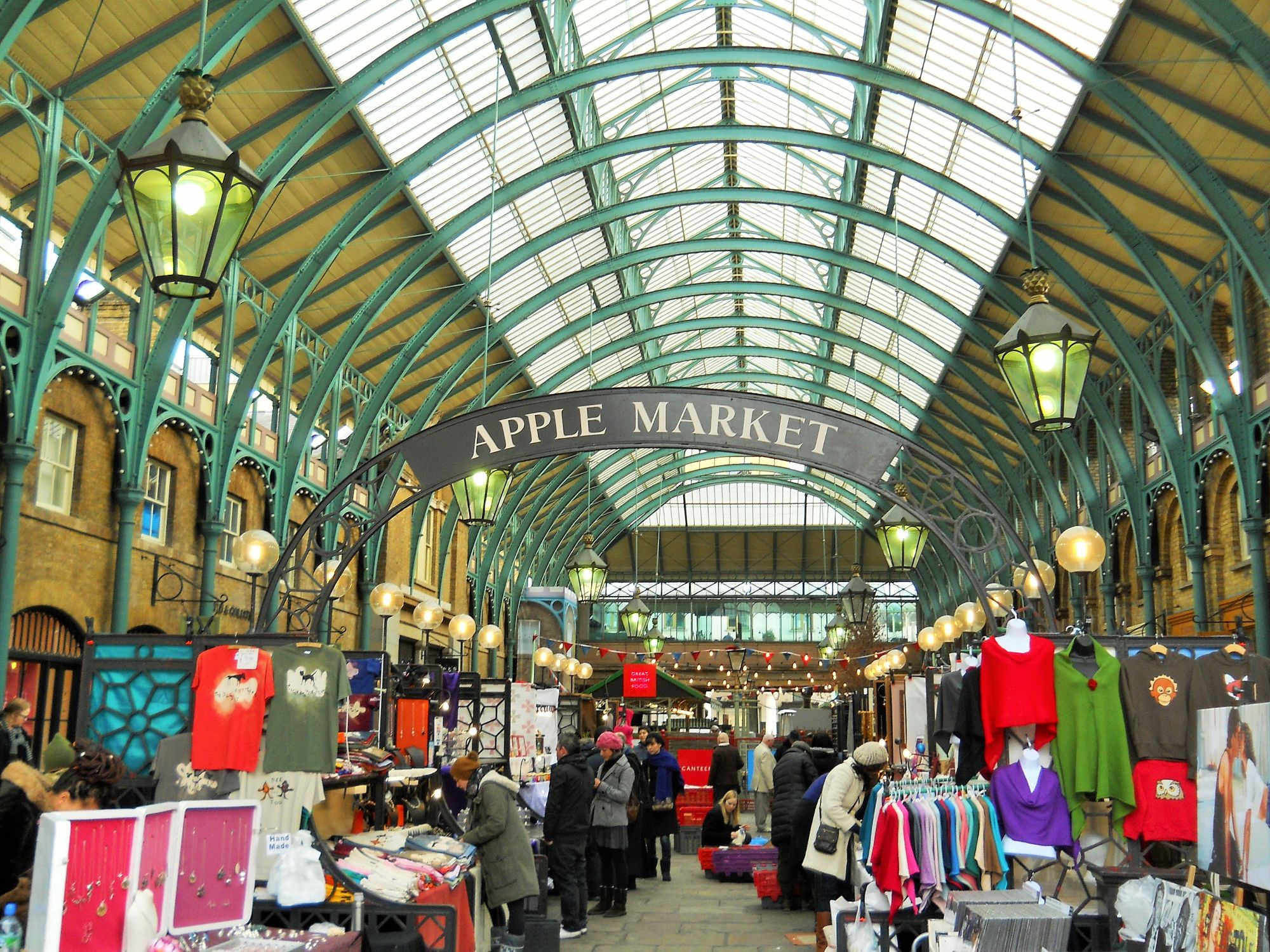Photo of the indoor craft market at Covent Garden. Stalls selling a selection of clothes and gifts.